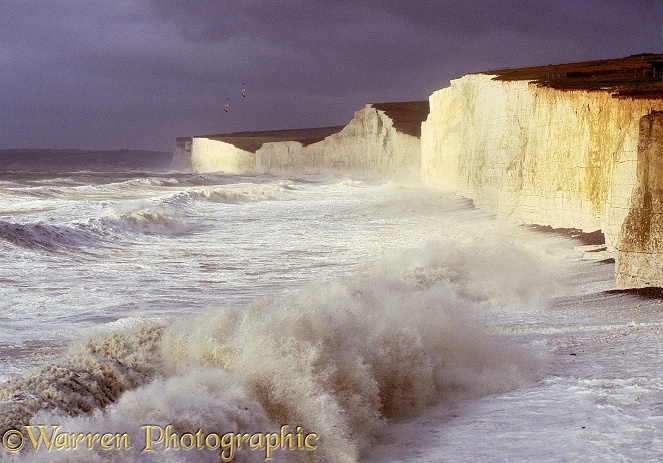 Chalk cliffs being pounded by huge waves whipped up during a winter storm.  Sussex, England
