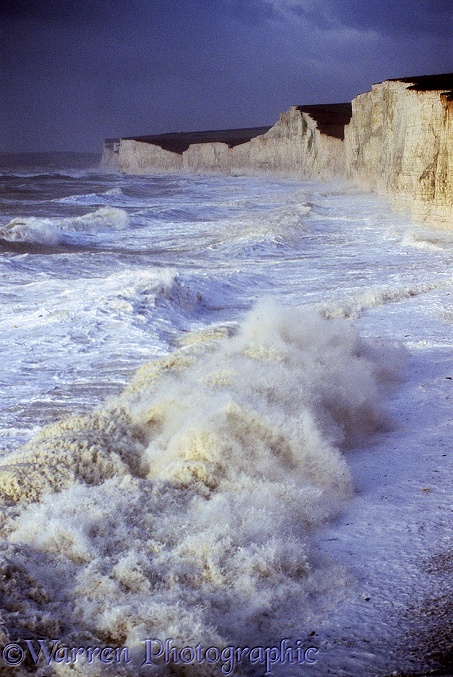 Chalk cliffs being pounded by huge waves whipped up during a winter storm.  Sussex, England
