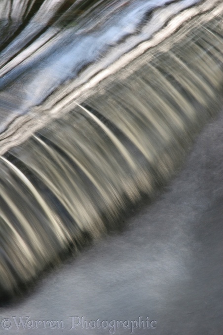 Water going over a small weir.  Surrey, England
