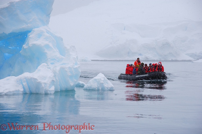 Tourists in zodiac boat viewing icebergs.  Antarctica