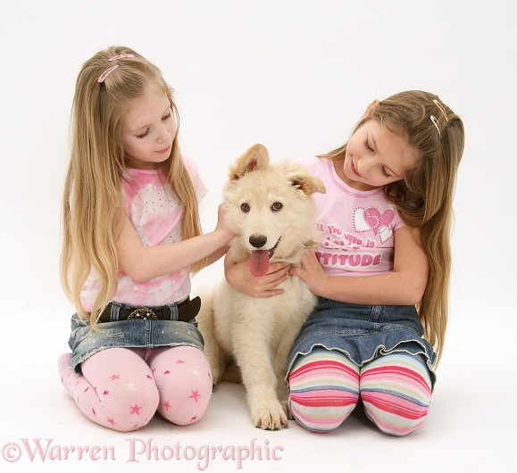 Girls with his white German Shepherd Dog pup, white background