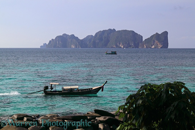 Long-tail boat and Koh Phi Phi Leh island.  Thailand
