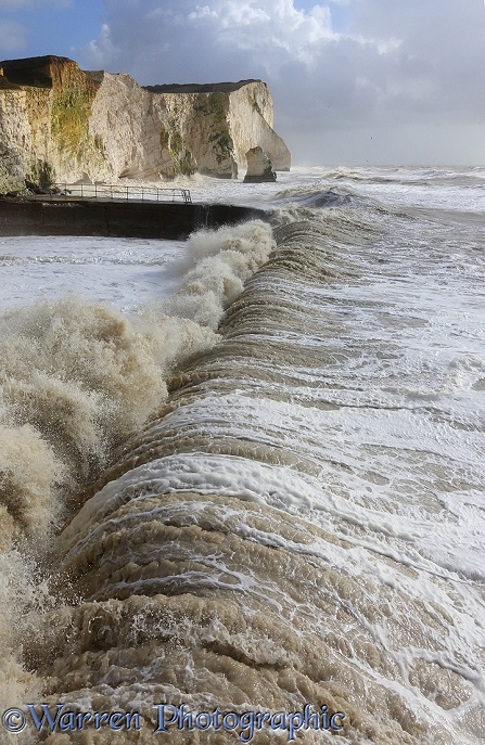 Waves breaking against sea wall and cliffs. Seaford, February 2014.  Sussex, England