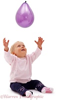 Baby Siena reaching up for a balloon