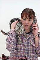 Woman phoning with cat on her shoulder