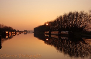 Canal and barge boats at sunset