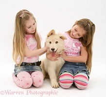 Girls with white Alsatian pup