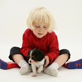 Little girl with Cavalier pup and welly boots