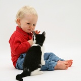 Toddler with Black-and-white kitten