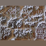 Rime-covered brick and stone wall