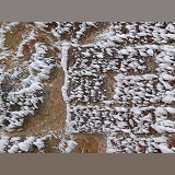 Rime-covered brick and stone wall