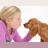 Girl face-to-face with Cocker Spaniel puppy