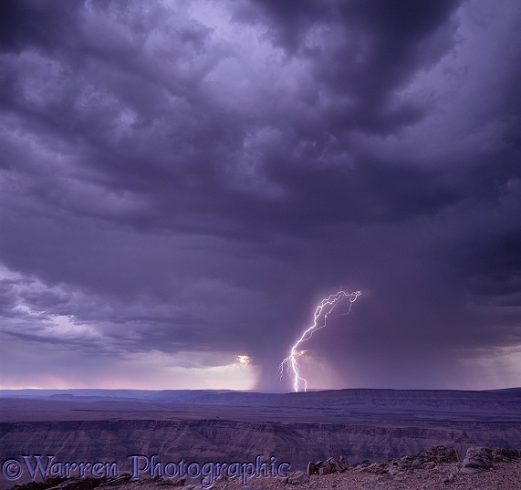 A bolt of lightning goes to ground over Fish River Canyon.  Namibia