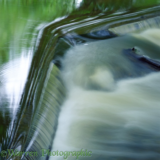Water going over a small weir.  Surrey, England