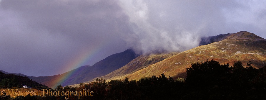 Mountain and clouds with rainbow.  Scotland
