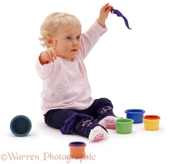 Siena, 13 months old, playing with plastic toys, white background