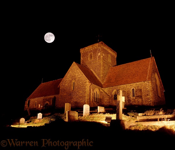 Full moon over floodlit St Martha's church.  Surrey, England