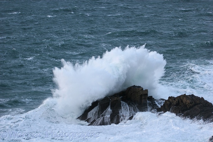 Wave splashing on a rock.  Lundy Island, England