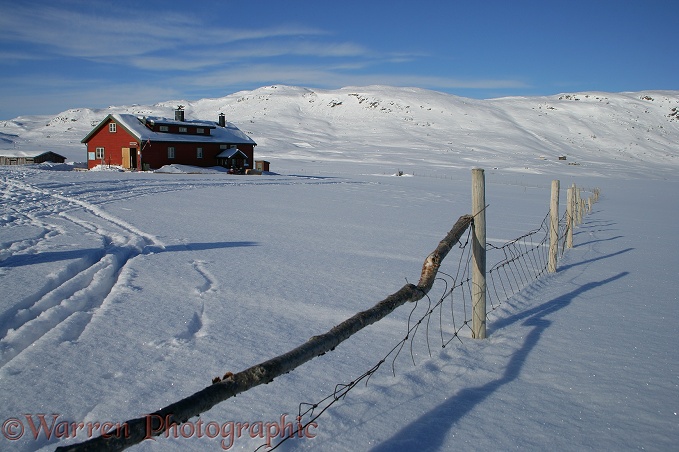 Alpine hut and fence with snow.  Geilo, Norway