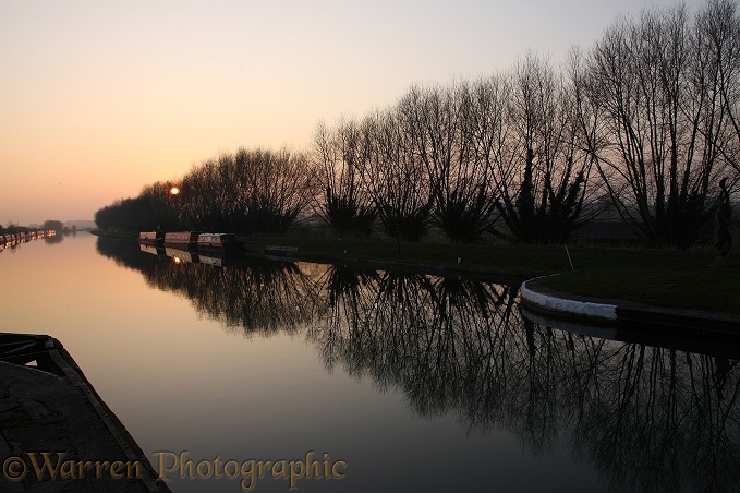 Canal and barge boats at sunset