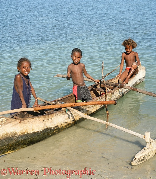 Malagasy children in a dugout canoe