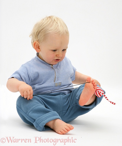 Toddler playing with Catnip mouse, white background