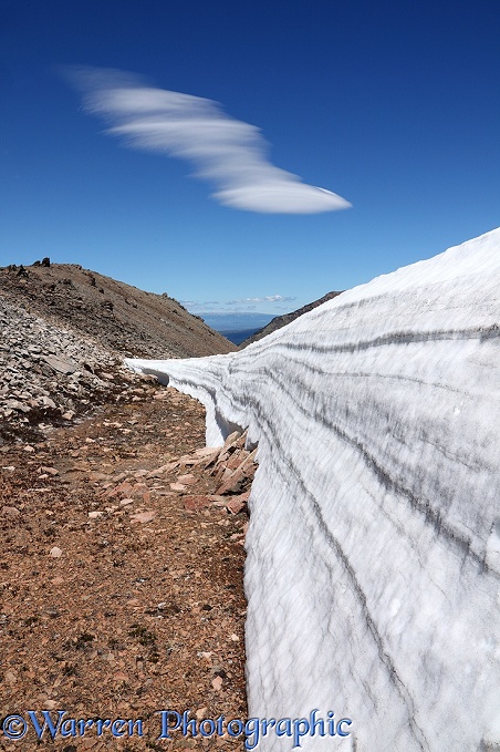 Rugged alpine landscape with snow and lenticular cloud.  Los Alerces National Park, Argentina