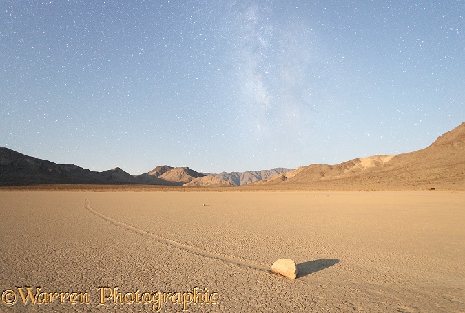 Sliding Stone or Moving Rock of Racetrack Playa, taken at night by moonlight, with the stars of the Milky Way in the background.  Death Valley, California