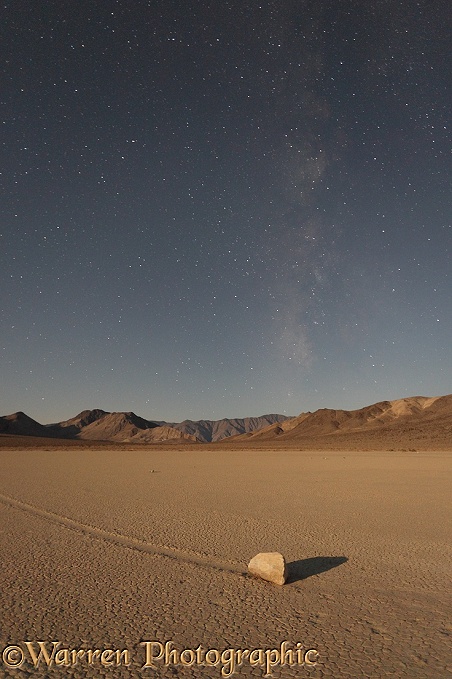 Sliding Stone or Moving Rock of Racetrack Playa, taken at night by moonlight, with the stars of the Milky Way in the background.  Death Valley, California