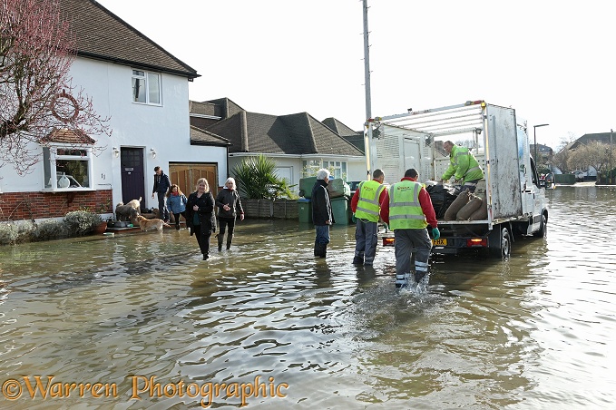 Handing our sand bags in flooded Weybridge 2014.  Surrey, England