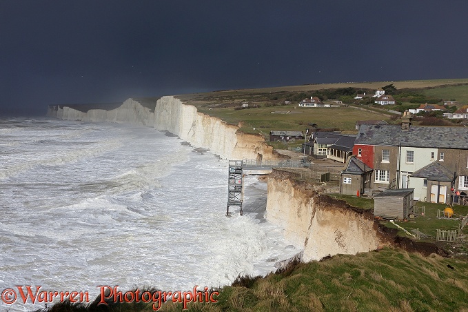 Chalk cliffs being pounded by huge waves whipped up during a winter storm at Birling Gap.  Sussex, England