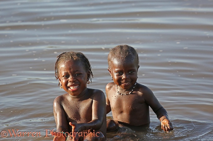 African girls playing in a distributary of the River Gambia