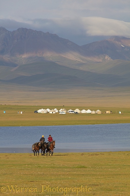 Horse riders and yurts by Song Kul Lake, Kyrgyzstan