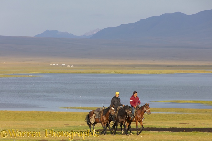 Horse riders by Song Kul Lake, Kyrgyzstan