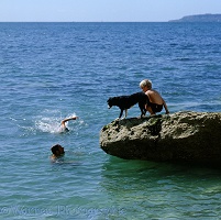 Boy and dog on a rock