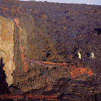 Men studying a lava flow