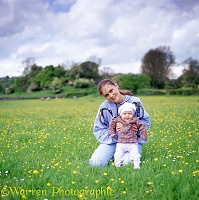 Woman and baby in buttercup field