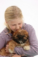 Girl cuddling Shih-tzu puppy