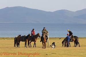 Horse riders and dogs by Song Kul Lake, Kyrgyzstan
