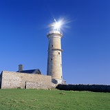 Lundy old lighthouse with sun reflection