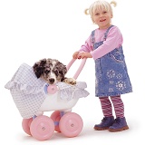 Little girl pushing puppy in toy pram