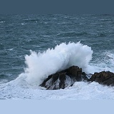 Wave splashing on a rock