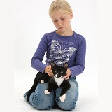Girl caressing black-and-white kitten