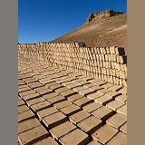 Adobe mud bricks drying and stacked ready for use
